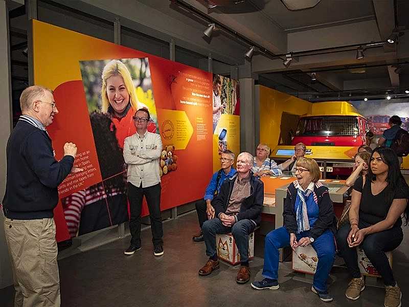 A group of visitors watching a BSL tour guide.