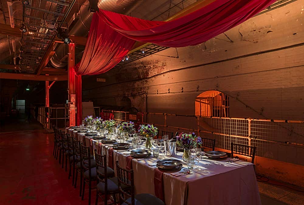 An event table set up in the Mail Rail venue space with lighting and decor.