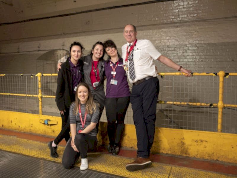 Five members from our Visitor Experience team posing for a photograph