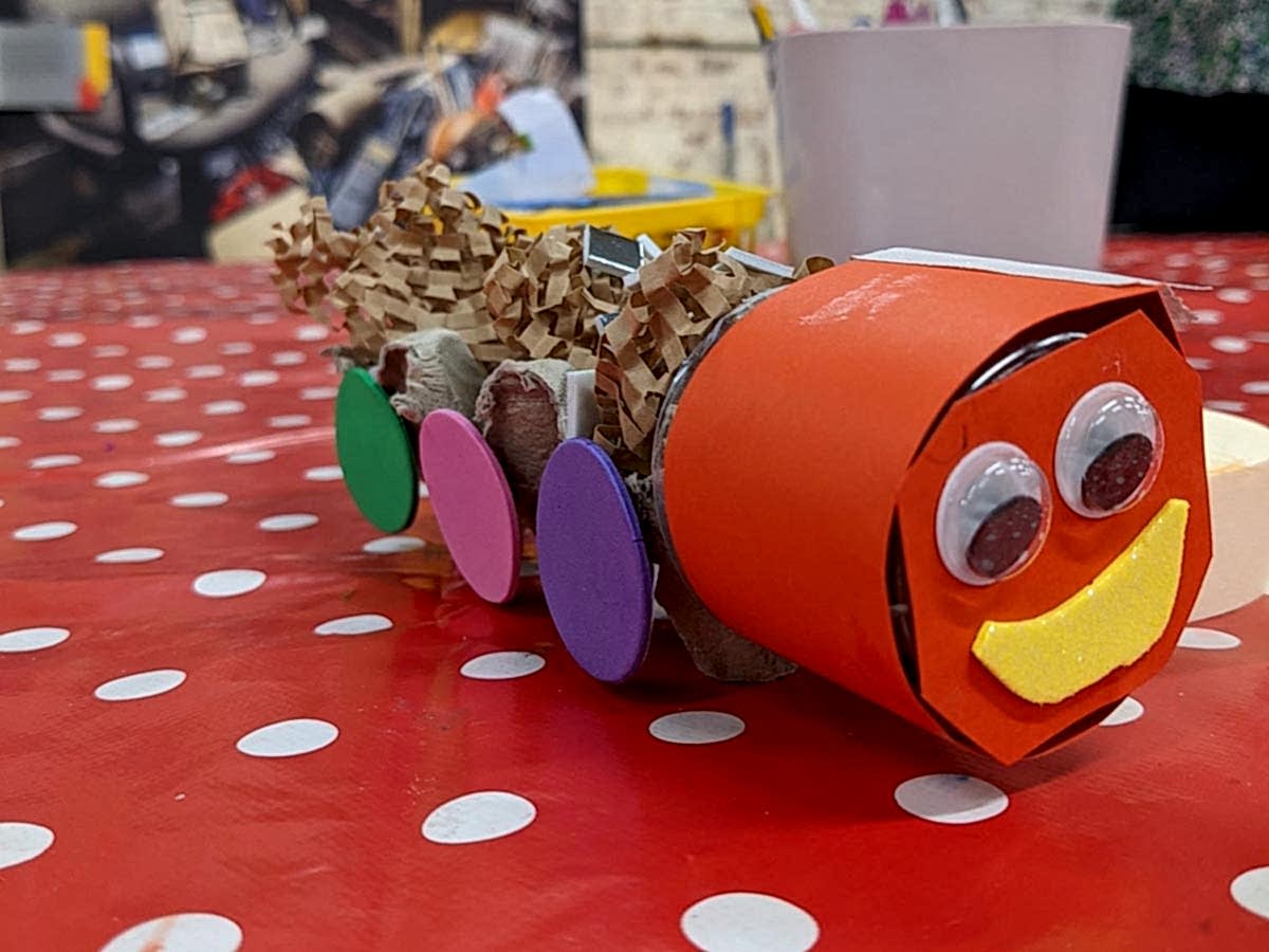 A paper caterpillar made from colourful scrap materials.