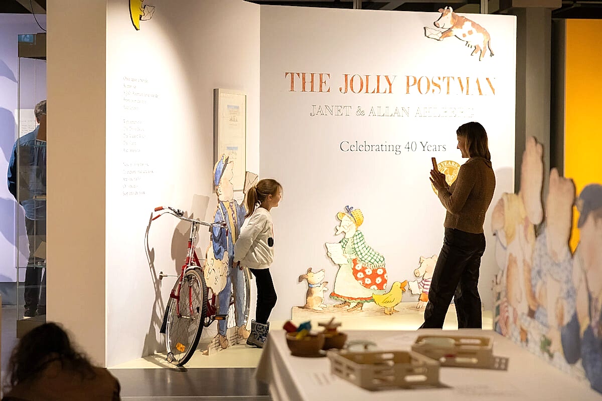 A family playing with props at a museum exhibit.